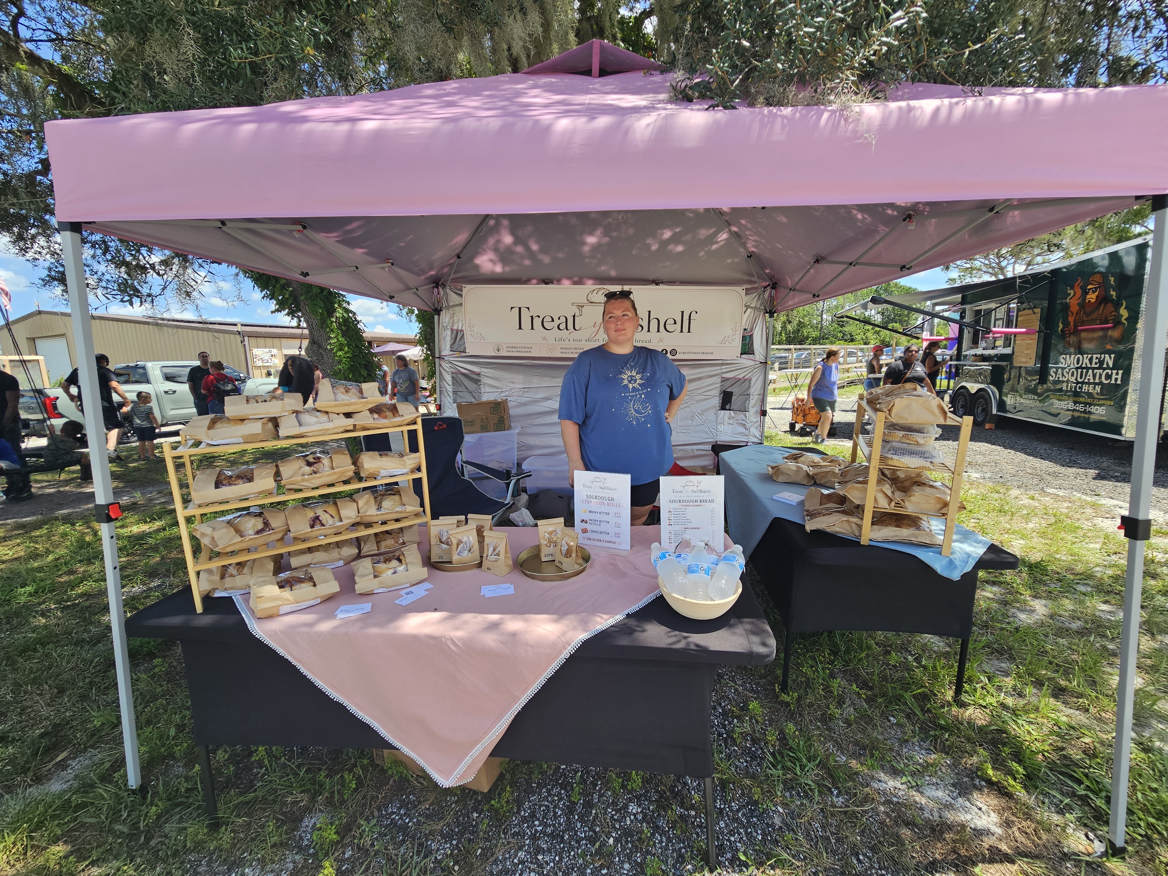 Our Treat Yo’ Shelf Bakery booth set up and ready with fresh-baked sourdough, cinnamon rolls, cookies, and more.